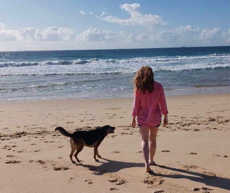 cervical cancer diagnosis blog post image, Carley walking on beach with dog